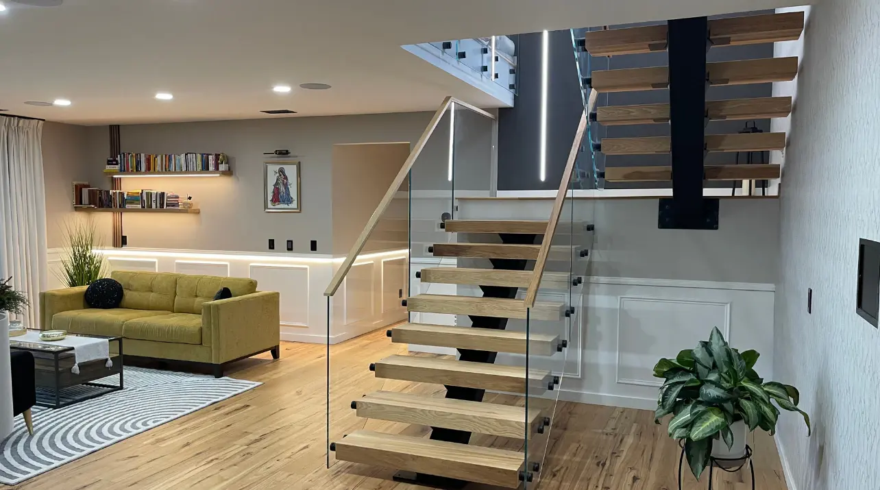 Open-plan interior with a glass-railed staircase and custom cabinetry