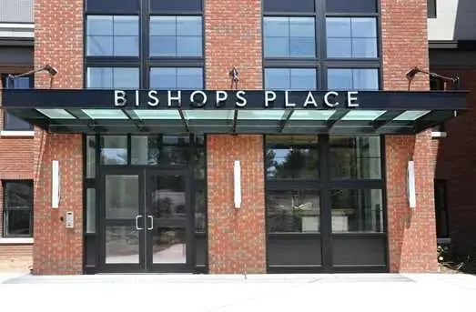 Bishops Place storefront entrance with brick facade and canopy