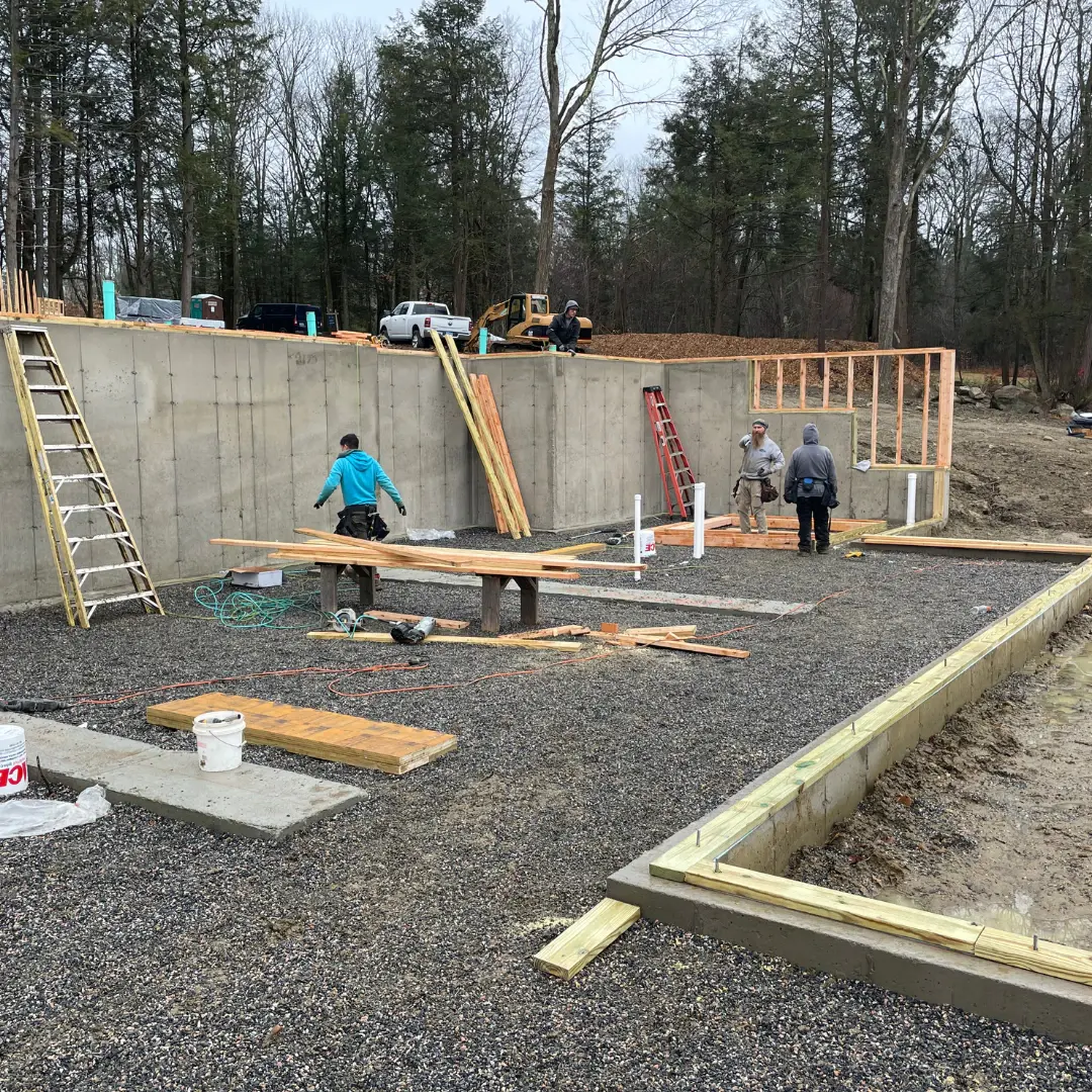 Crew setting the foundation walls at the start of a new home build